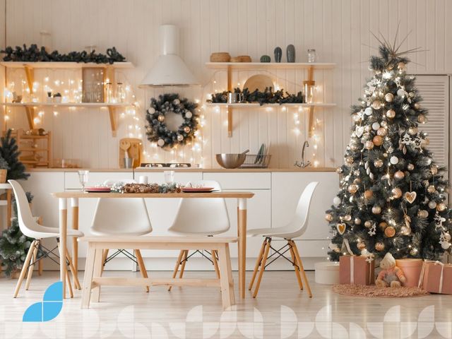 A kitchen with Christmas decoration and Christmas tree.