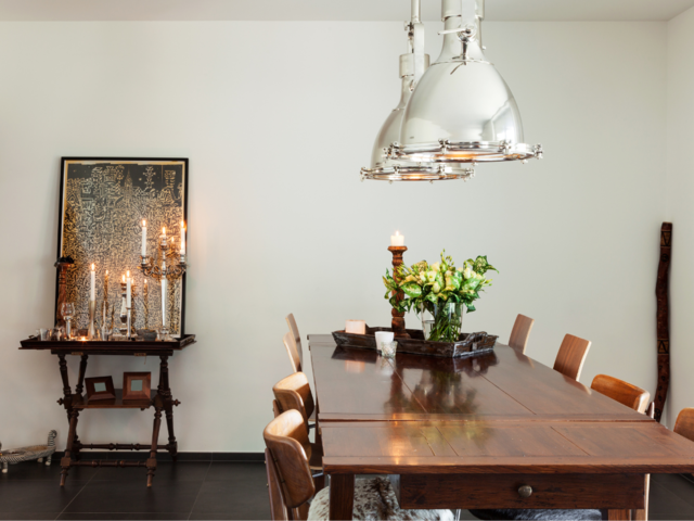 A traditional dining room design, with traditional ceiling lamps, and candles.