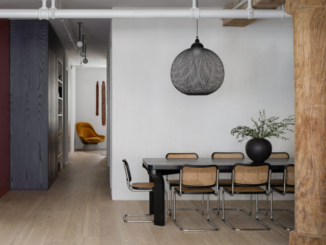 A dark/wood meeting room with very nice aesthetic design. 